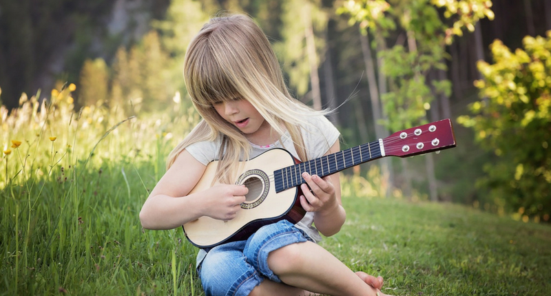 Un enfant joue de la guitare