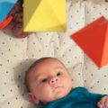 Un bébé sous un mobile Montessori
