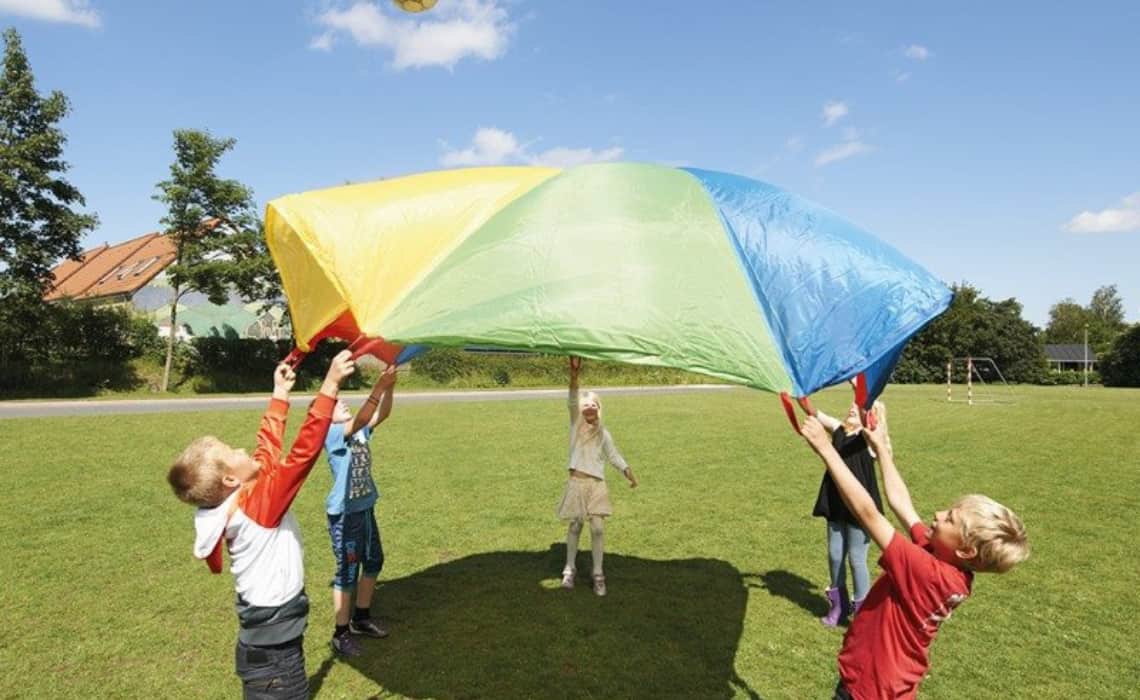Des enfants tiennent une toile de parachute
