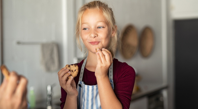 Une enfant mange des cookies